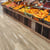Blond Farmhouse Oak lvp floors in the produce section of a grocery store; available to install as gluedown and rigid core