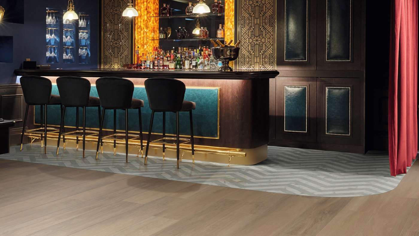Calacatta d'Oro LM33 and Pavimento Bianco LM42 herringbone floors mark the bar space from the Dune Oak RL24 floors of the restaurant