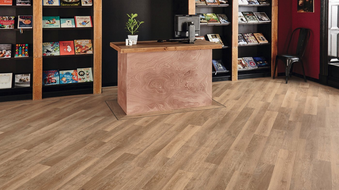 Charm added to a bookstore with Pale Limed Oak wood luxury vinyl floors and a Ebony design strip border