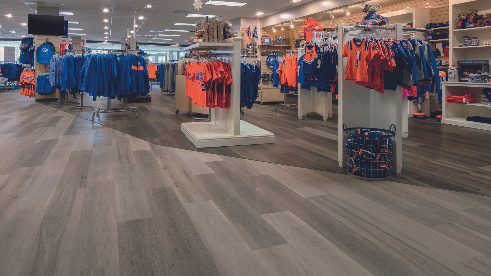 Apparel section of the Boise State Univesity Bronco Shop featuring Washed Grey Ash and Washed Velvet Ash lvt floors