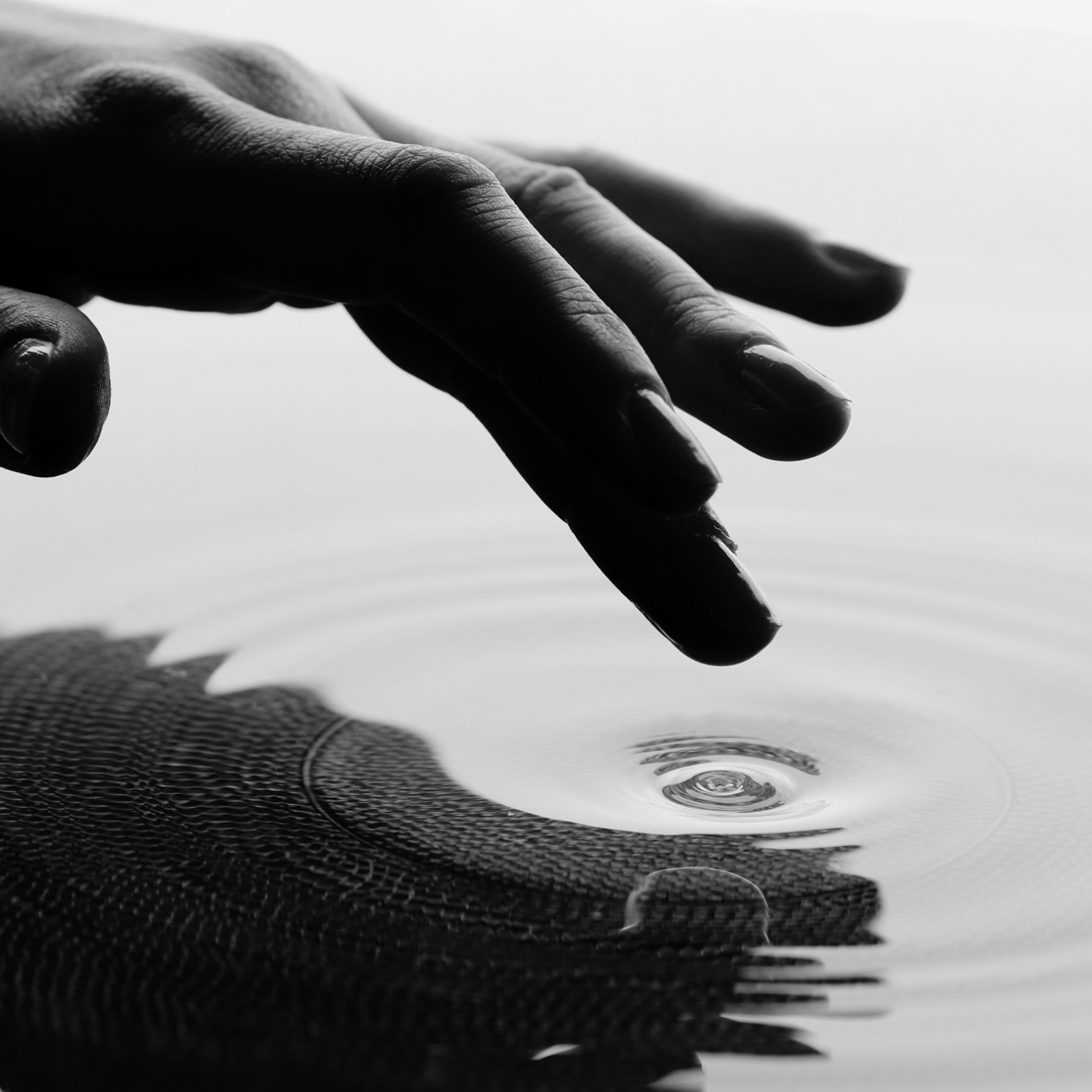 Hand touching water