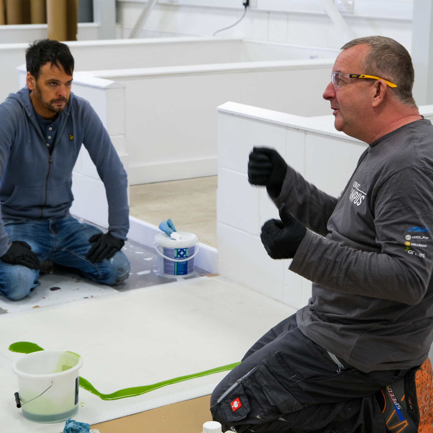 A trainer at a Karndean Commercial fitting course explaining to the attendees
