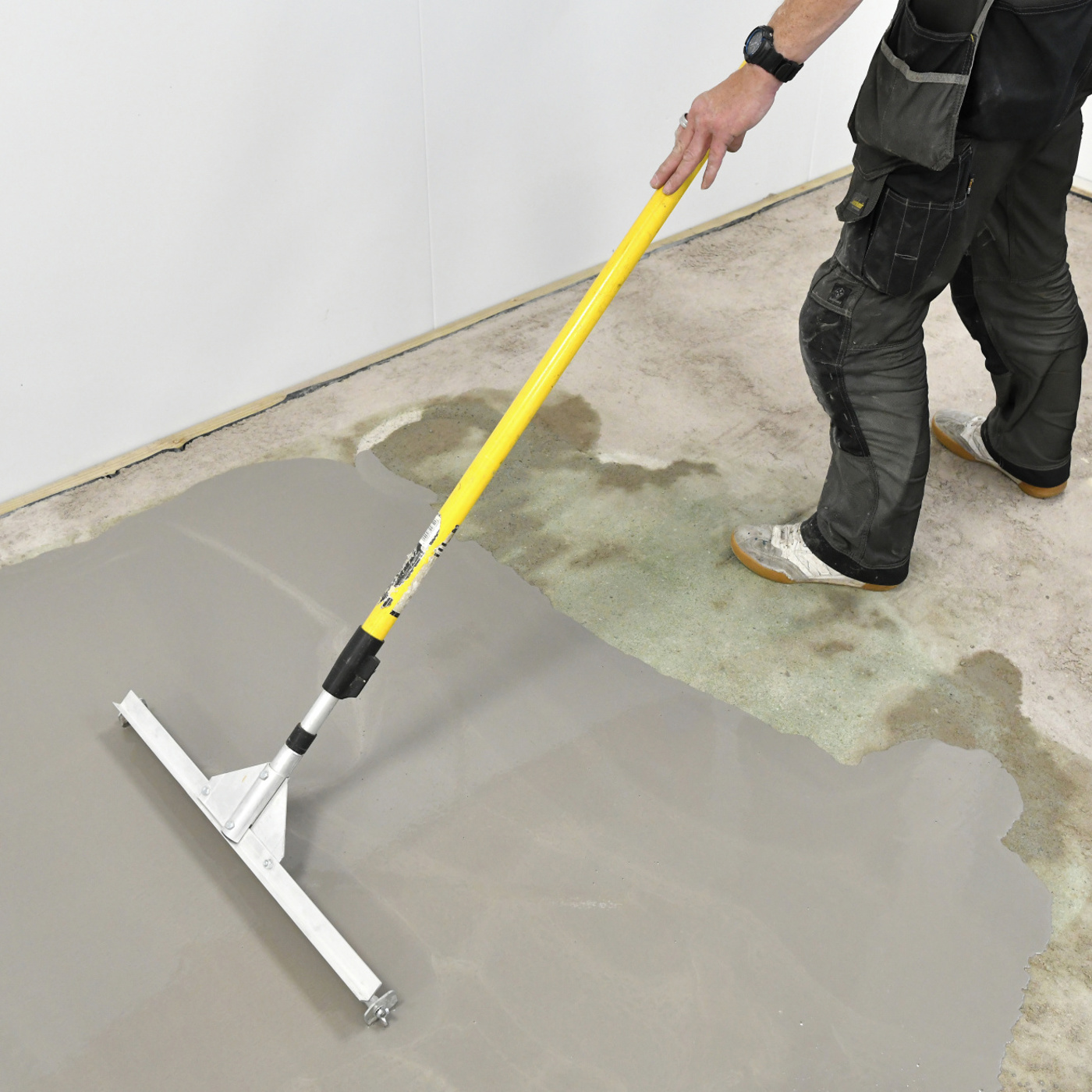 Installer spreading a generic floor leveler